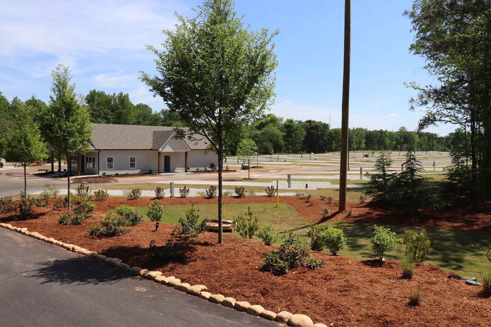 Landscaped entrance with the bath house and RV sites beyond