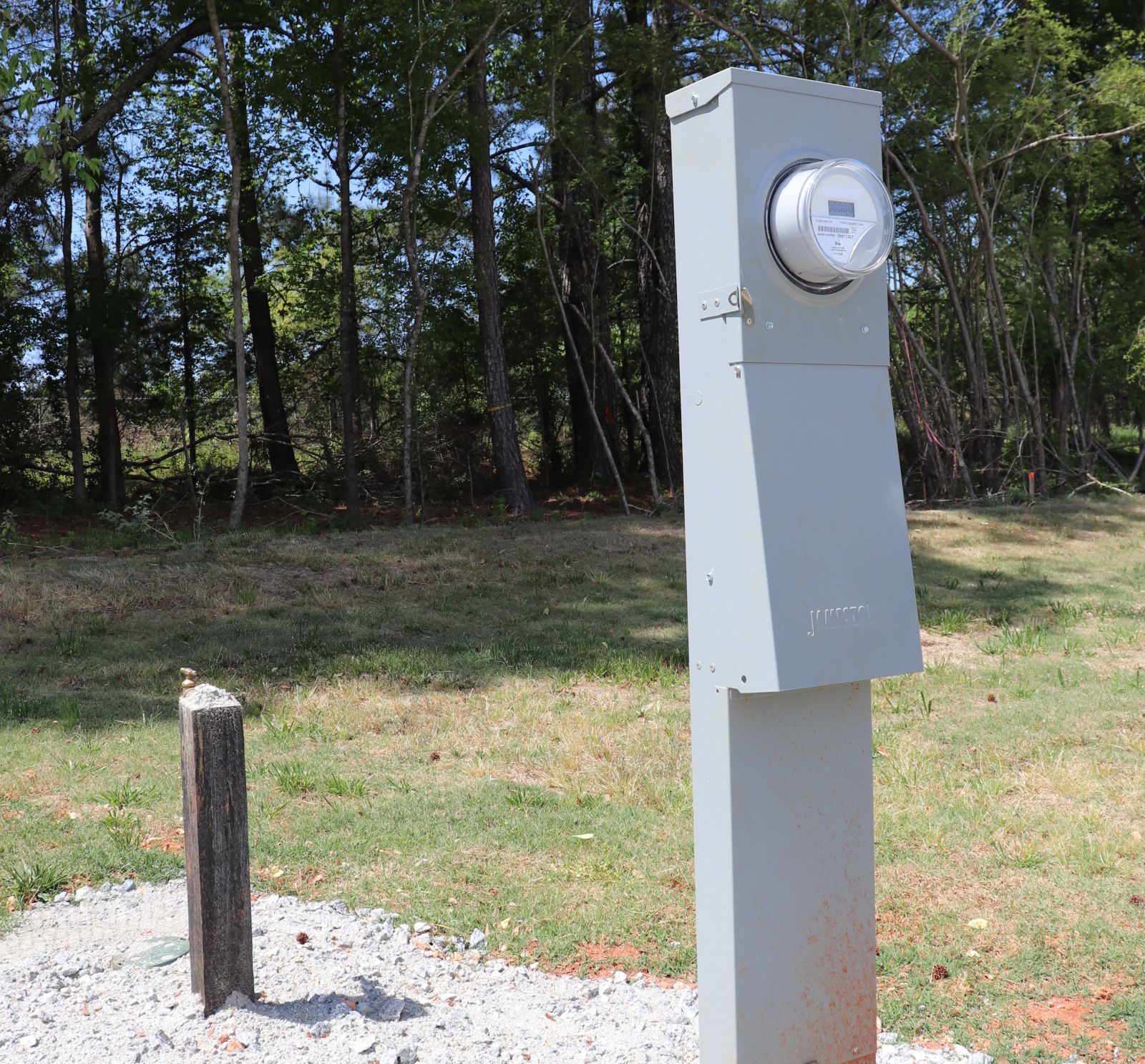 Metered power pedestal and water hookup at an RV site